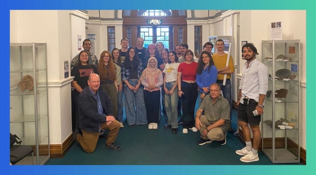 ForMovFluid PhD students and supervisors pose for a group photo in the hall of the Schhol of Earth and Environmental Sciences, University of St Andrews